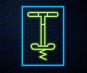 Glowing neon line Pogo stick jumping toy icon isolated on brick wall background. Vector.