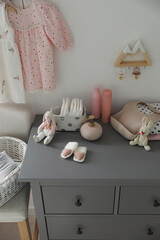 Stylish chest of drawers and accessories in child room