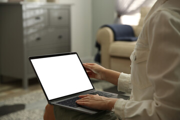 Woman using laptop at home, closeup. Space for design