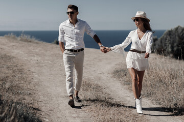 Fototapeta premium lifestyle engagement photo session young man and woman near yachts, couple in the city