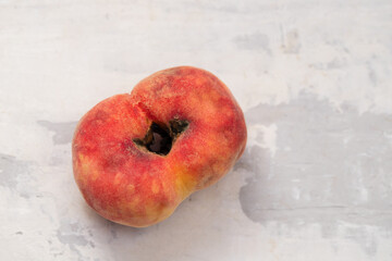 fresh organic peach on ceramic background