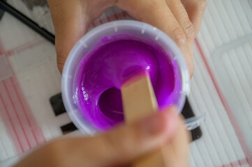 Little girl makes a homemade slime. Selective focus.