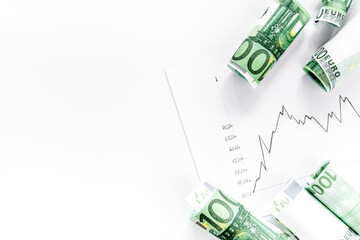 Diagram of stock market prices rates with euro banknote top view