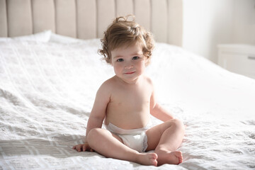 Cute little baby on bed at home