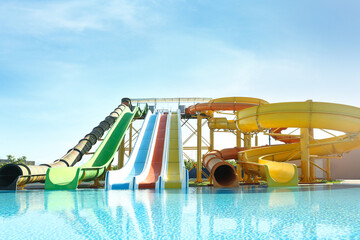 Different colorful slides in water park on sunny day