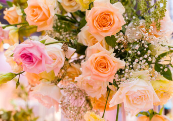  pink and white flowers in a glass vase on a wedding table
