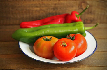 Vegetables on wood: tomatoes, red pepper and green pepper