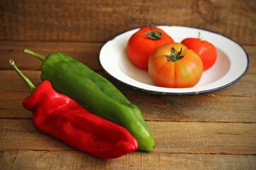 Vegetables on wood: tomatoes, red pepper and green pepper