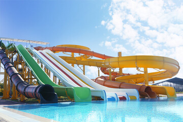 Different colorful slides in water park on sunny day