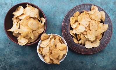 Potato Chips on an old wooden table. Close up food photo