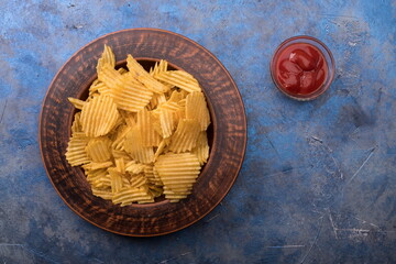 Potato Chips on an old wooden table. Close up food photo