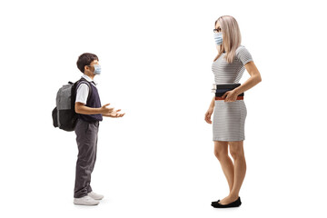 Schoolboy talking to a woman and wearing face masks