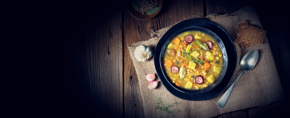Rustic pea soup with bacon and sausages