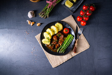 dumplings with beef goulash and green asparagus
