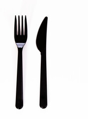 Black plastic fork and knife isolated on white background