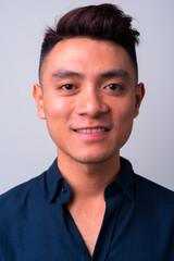 Obraz premium Face of happy young Asian businessman smiling
