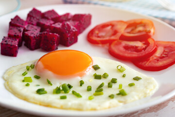 Egg, dragon fruit, tomatoes, for breakfast. Close up.