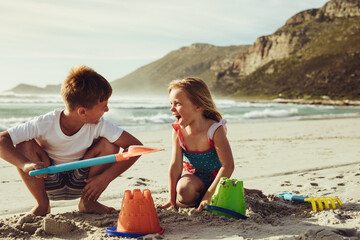 Kids building sandcastle on the beach - Powered by Adobe