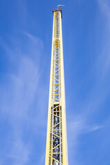 Part of the attraction in the amusement park. High steel tower for downhill and ascent of visitors