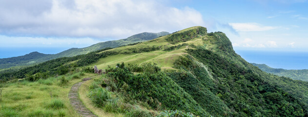 Beautiful grassland, prairie in Taoyuan Valley, Caoling Mountain Trail passes over the peak of Mt....