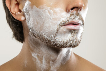 Man with a shaving cream on his face