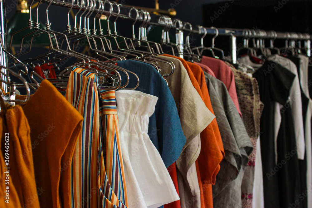 Wall mural Women's clothes on hangers in the wardrobe