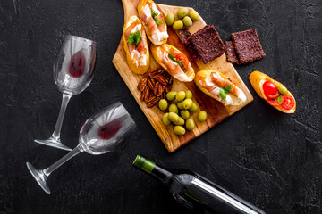 Bruschetta with prosciutto and red wine in bottle from above