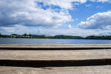 Beautiful wooden pier on the background of a blue forest lake