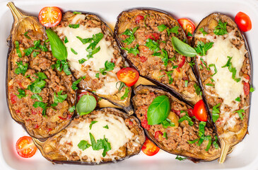 Stuffed eggplants with grown beef meat, tomatoes and mozzarella cheese. Top view.