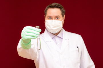 Scientist or medical in lab coat holding test tube with reagent, Biochemistry laboratory research.Burgundy background.