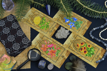 Mystic still life with tarot cards, conifer branch and crystals on witch table.