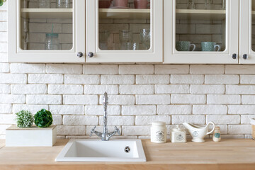 White kitchen in apartment with modern interior