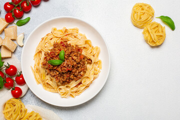 Traditional italian pasta - Tagliatelle all ragù. Egg pasta with meat  and tomatoes bolognese sauce. Ingredients.