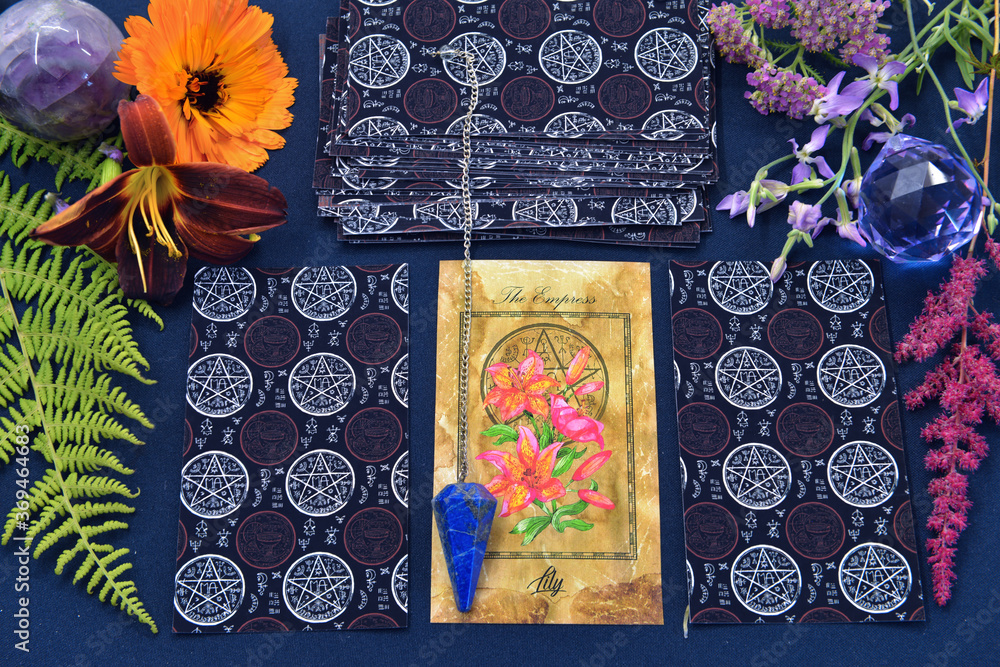 Wall mural mystic still life with tarot cards, crystal and flowers on witch table.