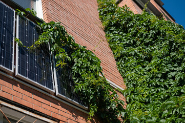 Close-up of solar panels on a red brick wall. Alternative energy source. Caring for the environment.