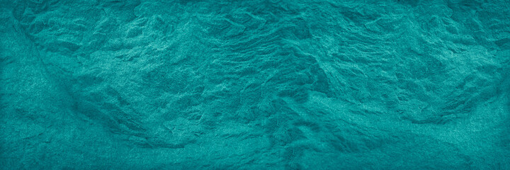 Blue green stone background. Abstract turquoise background. Toned stone texture. Wide banner with a...