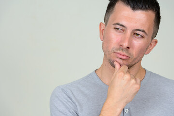 Fototapeta premium Portrait of young handsome man thinking and looking down