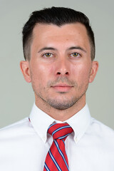 Portrait of young handsome businessman looking at camera