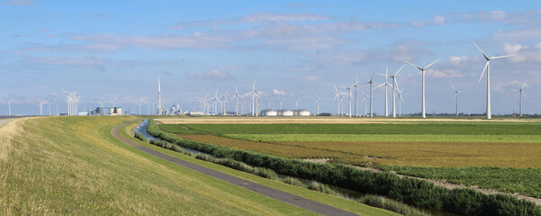 Panoramic summer view of the landscape and multi-fuel power station with wind turbines at...