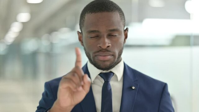 Portrait of African Businessman saying No with Finger Sign 