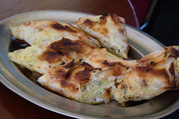 Traditional Serbian savory pie - pita zeljanica with herbs and cottage cheese