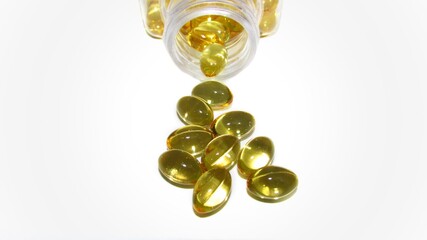 Cod liver oil  or fish oil gel capsules  on white background. It contains omega 3 fatty acids ,...