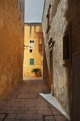 Fototapeta na wymiar Little old European cobblestone street in Mdina, Malta, Europe