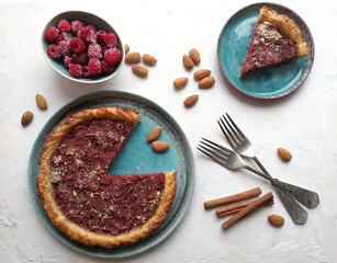 Raspberry pie in turquoise plate on white background