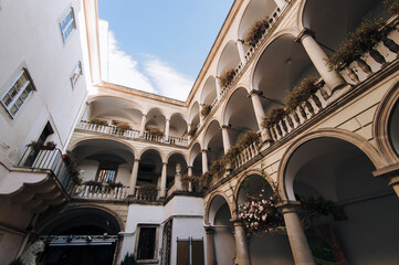 Ancient architecture of the Renaissance in Lviv, Ukraine. Italian courtyard with a three-story arcade. View of the patio in winter. © shchus