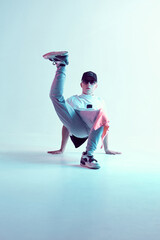 Cool young breakdancer guy dancing hip-hop in neon light. Dance school poster. Battle competition announcement
