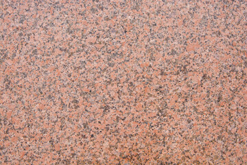 Dark pink granite texture with black splashes. A natural stone.