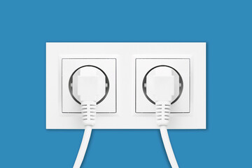 Brand new electrical socket isolated on blue wall. White wire plug plugged in. Renovated studio apartment power supply background. Empty copy space double white plastic power outlet.