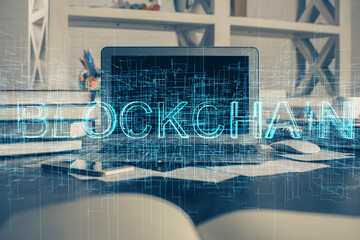 Multi exposure of blockchain theme hologram and table with computer background. Concept of bitcoin crypto currency.