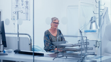 Lonely old woman in hospital bed waiting for doctor. Healthcare in modern hospital or private clinic, disease prevention and consultation in medic office treatment medication diagnosis expertise